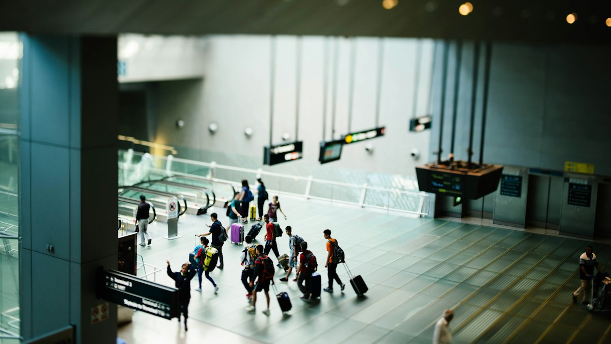 Travelers walking through an airport terminal